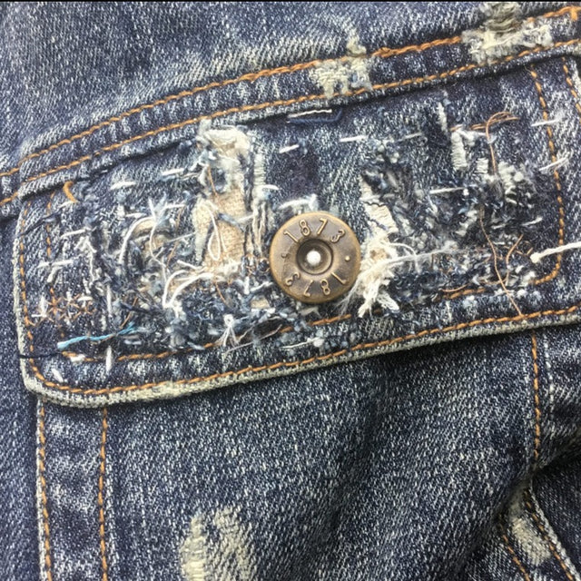 stitched distressed denim pocket